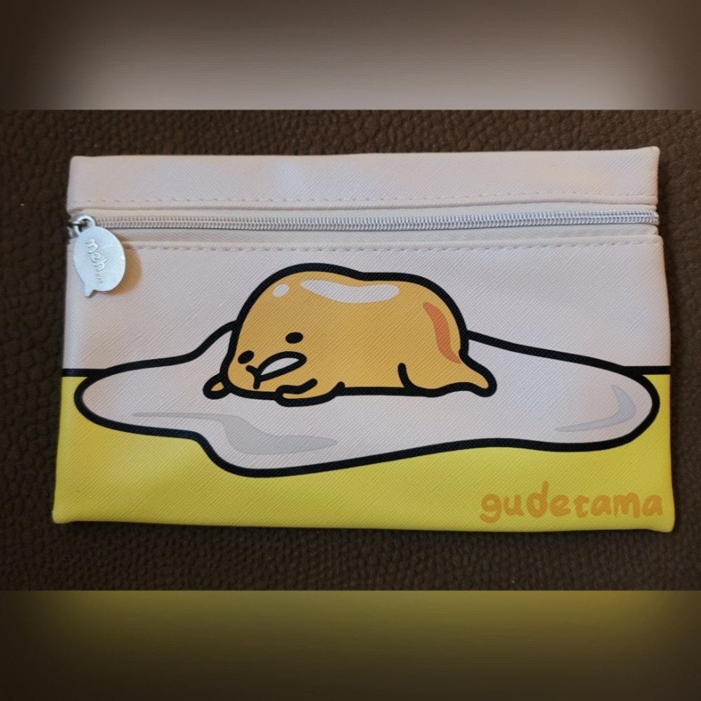 GUC. Ipsy, gudetama yellow, and white makeup bag.